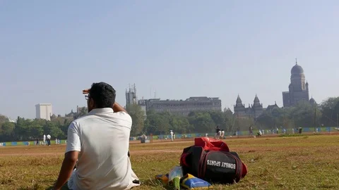 A boy looking at game of cricket in the Azad Ground opposite V.T. station. Stock Footage 74180585