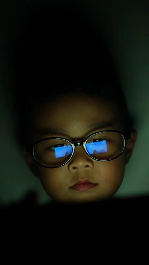 The boy is looking at his cell phone screen at night. 스톡 동영상 333888016