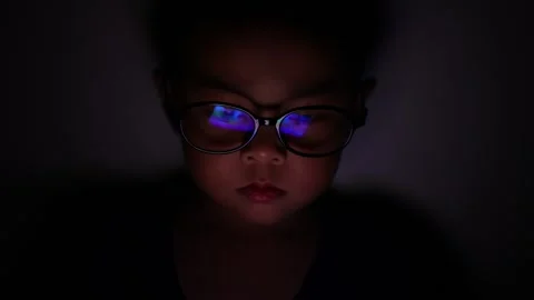The boy is looking at his cell phone screen at night. Stock Footage 333888025