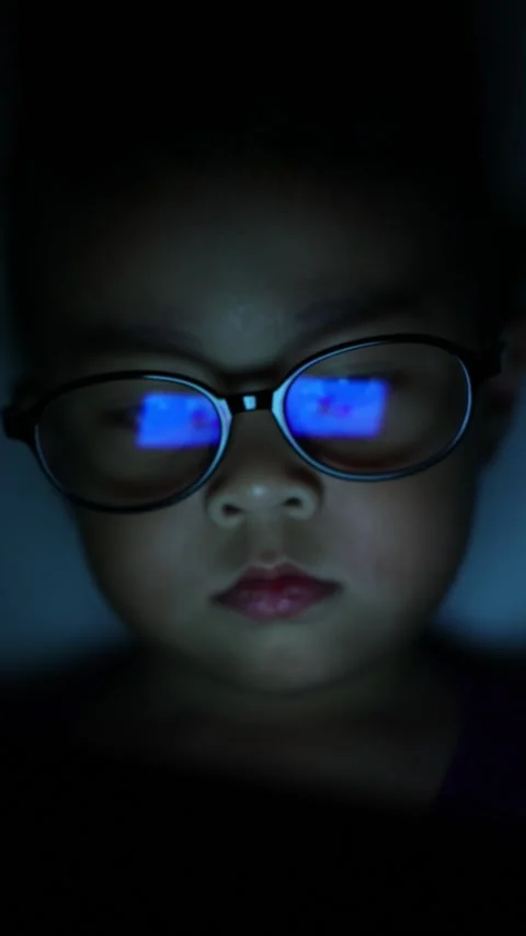 The boy is looking at his cell phone screen at night. Stock-Footage 333888054