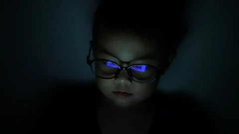 The boy is looking at his cell phone screen at night. Stock-Footage 333888059
