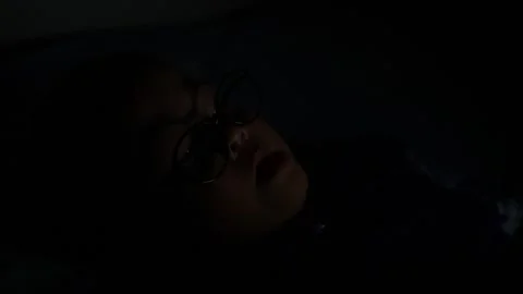 The boy is looking at his cell phone screen at night. Stock-Footage 333888207