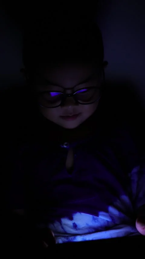 The boy is looking at his cell phone screen at night. Stock-Footage 333888215
