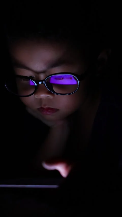 The boy is looking at his cell phone screen at night. Stock-Footage 333888216