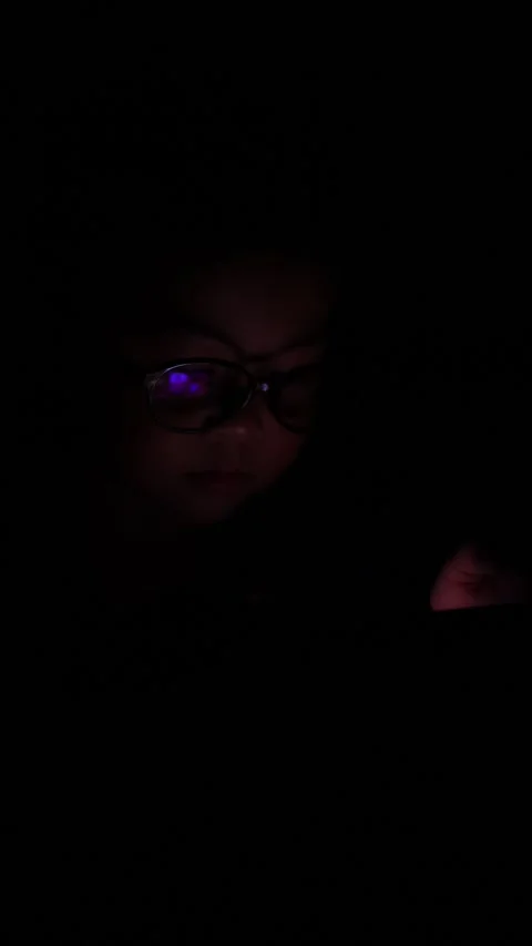 The boy is looking at his cell phone screen at night. Stock-Footage 333888258