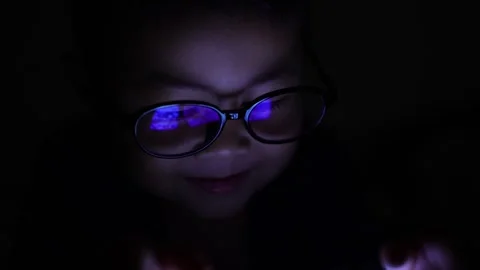 The boy is looking at his cell phone screen at night. Stock Footage 333888322