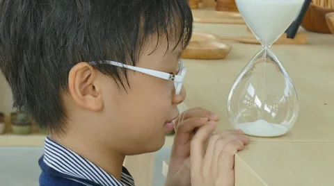 Boy looking at hourglass Stock Footage 57291035