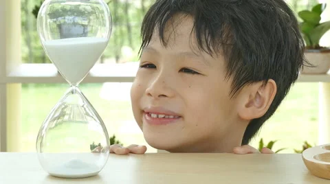 Boy looking at hourglass Stock Footage 57291537