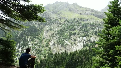 A boy looking at the mountain view in the shade Video stock 157735092