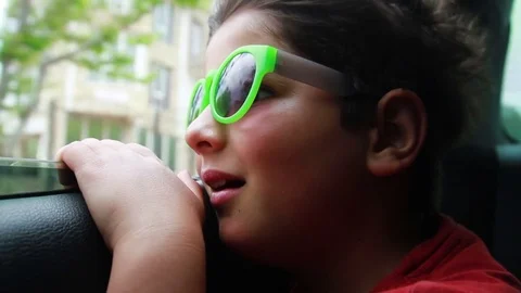 The boy is looking at the open car window Stock Footage 76433672