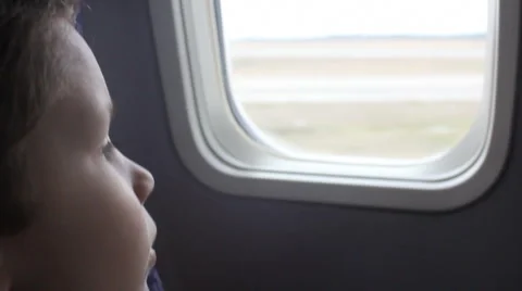 Boy looking out aiplane window Stock Footage 1067264