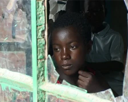 Boy looking out broken classroom  window Stock Footage 11323446
