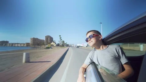 Boy looking out the car window. Summer trip with family. Stock Footage 112323433