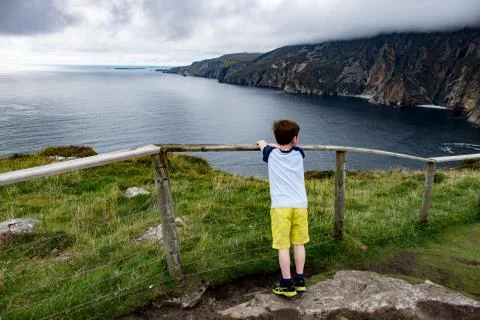 Boy looking out over Slieve League Cliffs, County Donegal, Ireland Stock Photos