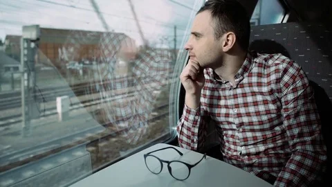 Boy looking out train window outside, in the evening, travel. 4K Video stock 74198539