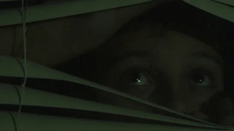 Boy Looking Out Window at Night 動画素材 83256261