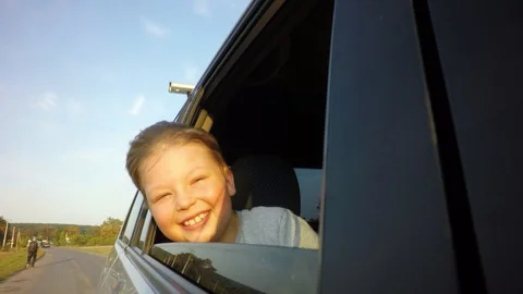 Boy looking out window while driving in car Stock-Footage 94735494