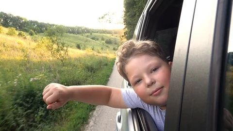 Boy looking out window while driving in car Video stock 111410264