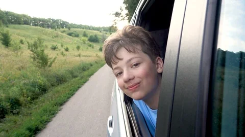Boy looking out window while driving in car Video stock 111410570