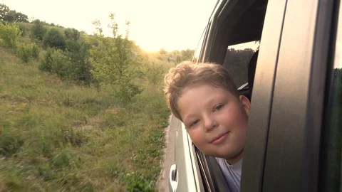 Boy looking out window while driving in car Video stock 111410715