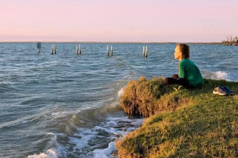Boy looking over lake Stock Photos