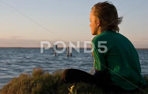 Boy looking over lake Stock Photos