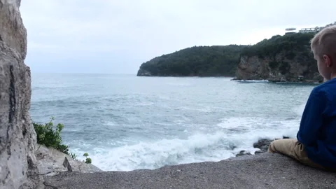 Boy Looking at Sea on Medieval Wall Stock Footage 140290264