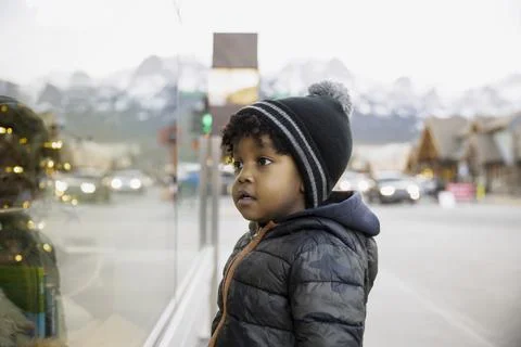 Boy looking in shop window Stock Photos