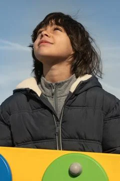 Boy looking up at sky pondering future hope Stock Photos