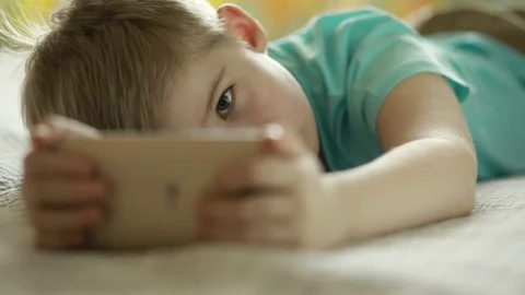  Boy looking at a smart phone Stock Footage 72870145