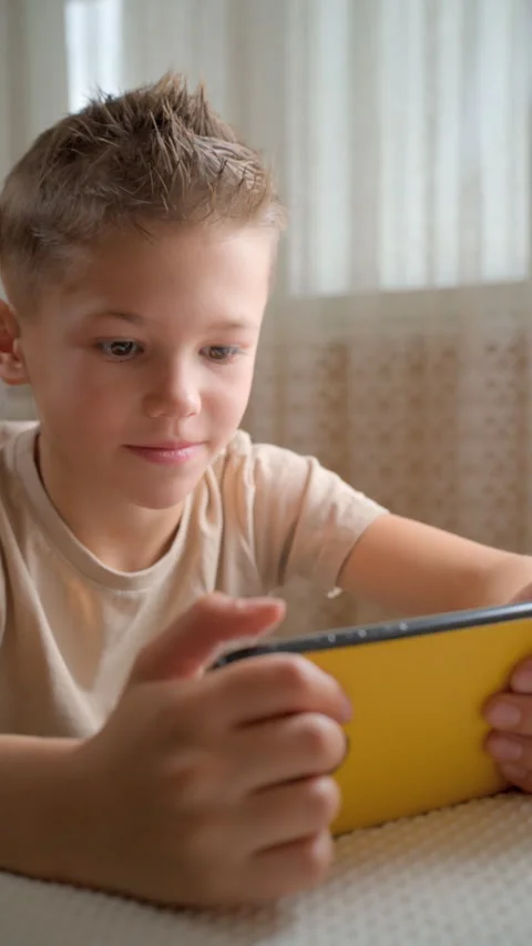 Boy looking at smartphone screen at home. Stock Footage 329632396
