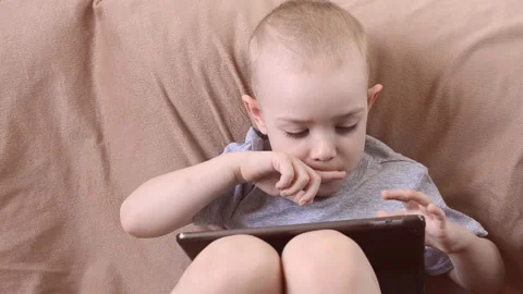 Boy looking for something on the tablet Stock Footage 172538112