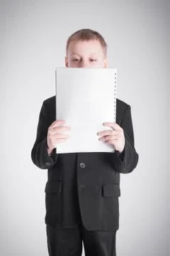 Boy looking at a stack of paper Stock Photos