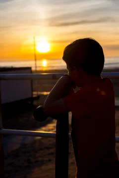 Boy looking at sunset Photos