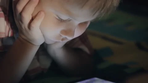 Boy looking at tablet computer at night Stock Footage 91707743