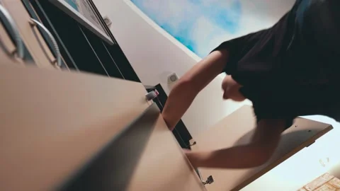 The boy is looking for things in the closet. bottom view Stock Footage 190022582