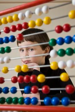 A boy looking through an abacus Stock Photos