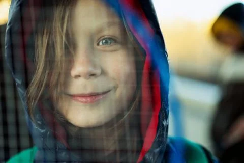 Boy looking through a badminton racket net Stock-Fotos