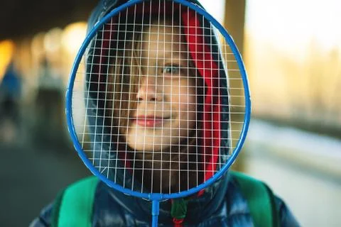 Boy looking through a badminton racket net Stock Photos