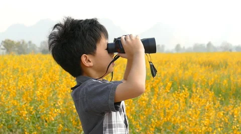 Boy looking through binoculars Stock Footage 62351868