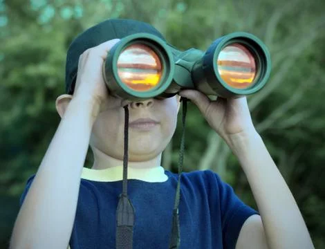 Boy looking through binoculars Foto stock