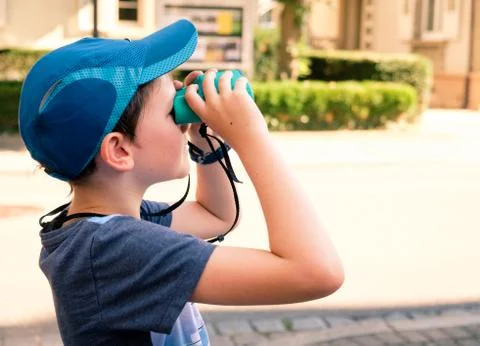 Boy looking through binoculars Stock Photos