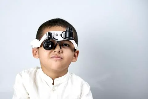 Boy looking through magnifying eyeglasses Stock Photos