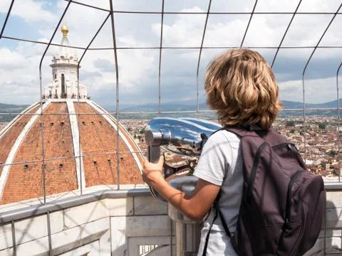 Boy looking through a sightseeing binoculars the dome of basilic Stock Photos