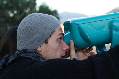 Boy  looking through a telescope Stock Photos