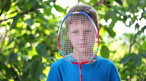 Boy Looking Through Tennis Racket Stock Footage 40671164