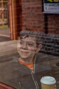 Boy looking through a train window Stock Photos