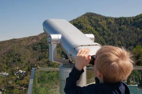 Boy looking at touristic telescope of Batumi view, Georgia. Stock-Fotos