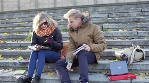Boy looking worried while doing homework and talking with his girlfriend Video stock 57892554