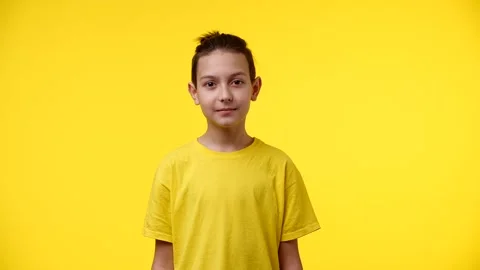 The boy looks at the camera and blinks Stock Footage 166063770